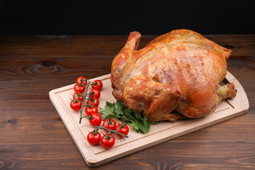 homemade roasted chicken on dark wooden background