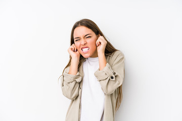 Young caucasian woman  isolated covering ears with hands.