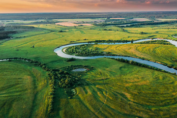 Belarus. Aerial View Of Green Forest, Meadow And River Landscape In Sunny Evening. Top View Of European Nature From High Attitude In Summer Sunrise. Bird's Eye View