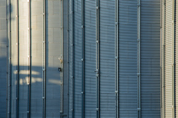A large modern plant for the storage and processing of grain crops. view of the granary on a sunny day against the blue sky. End of harvest season.