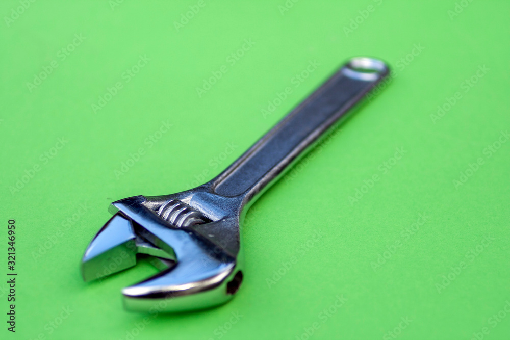 Wall mural adjustable wrench on green background