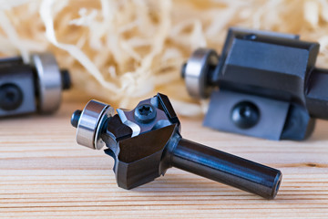 Trimming shank router cutters. Milling cutting tools on wood background. Shaping copying endmills...