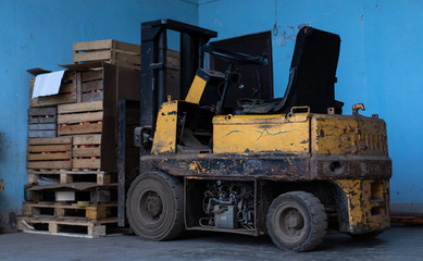 Old forklift, workshop, yellow closeup