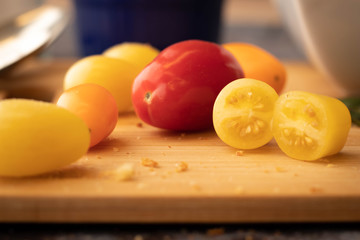 Closeup of Red, Yellow and Orange Tomatoes on a Cutting Board