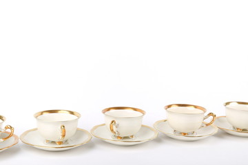 line of tea cups on white background with copy space