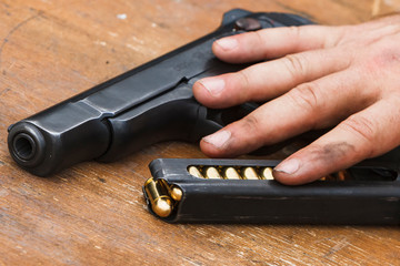 Hand and pistol with cartridge holder.