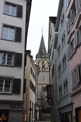 Fototapeta na wymiar St. Peter's Church in Zurich view from a narrow street.