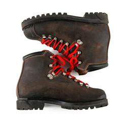 Pair of vintage classic hiking boots with red laces on white background isolated