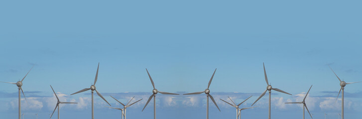 Wind turbines against blue  sky. Environmentally friendly banner or header