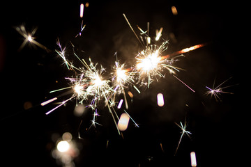 Sparkler burning in the dark during New Years night celebration	