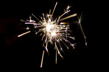 Sparkler burning in the dark during New Years night celebration	