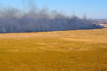 Steppe fire. Burning dry grass, fire smoke