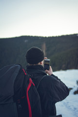 Fototapeta na wymiar tourist in the mountains taking pictures