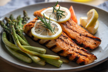 grilled salmon fillet on plate with asparagus
