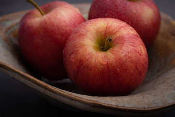 Closeup Macro Photo of 3 Red Apples in a Ceramic Bowl