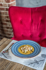 broth served in a modern blue plate with beard