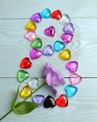 Eight of glass hearts and lisianthus flowers, composition for Women's Day, March 8.