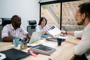 Colleagues working in office sitting at table
