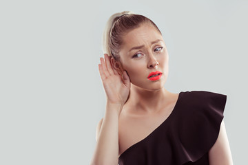 Curious worried woman with hand to ear carefully secretly listening to gossip conversation isolated...