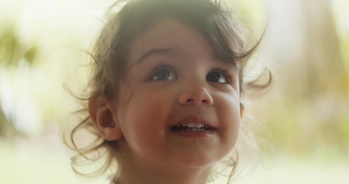 Portrait of beautiful little girl having fun on vacation. Cinematic 4K footage.