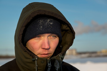 Portrait of a worker in protective workwear with a hood on his head