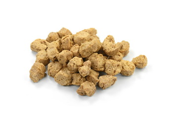 Raw dehydrated soy meat on white background. Pieces of dry soy meat. Textured Soy Protein.