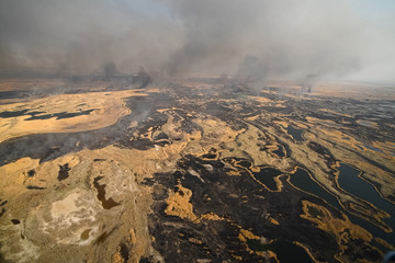tundra fire. Burning dry grass and peat bogs, fire and smoke in