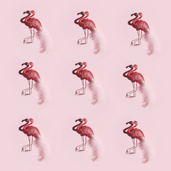 Lots of glamorous pink flamingos on a pink background. Pattern with birds with hard shadows on paper.