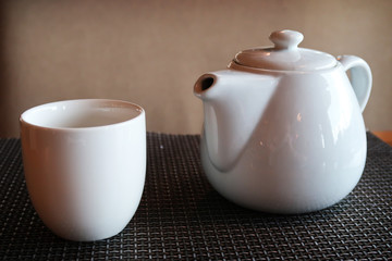Teapot and empty cup on a table