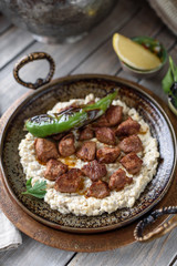 Turkish Sauteed Lamb Meat Served with Smoked Eggplant and Yogurt Puree, Garnished with Grilled Hot Pepper. Ali Nazik Kebab