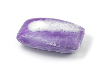 Soap bar with foam isolated on white background. Wet bar of soap.