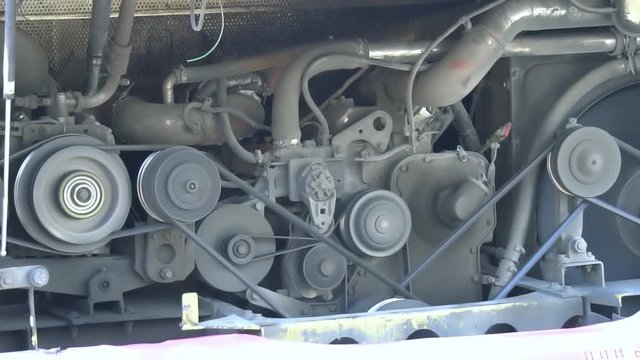 Working bus, truck diesel engine with motor belt, pulley, gear, engine equipment details.