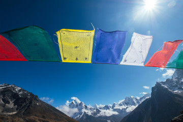Holy buddhist praying multicolored flags with mantras flapping and waving on the  strong wind with...