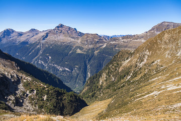 Fototapeta na wymiar Aerial panorama view of Calanca valley and Swiss Alps on border of Grisons and Ticino, on the hiking trail from Rifugio Pian Grand to Capanna Buffalora on sunny autumn day, Graubuenden, Switzerland