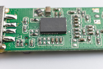 USB wifi adapter. Green printed electronic circuit board  having small electronic components and chips.