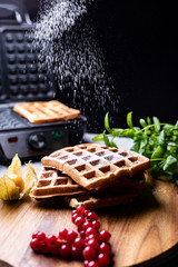 Classic golden Belgium waffles sifted with powdered sugar