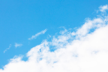 Blue sky background and white clouds soft focus, and copy space
