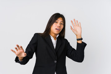 Young asian business woman being shocked due to an imminent danger