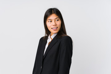 Young asian business woman looks aside smiling, cheerful and pleasant.