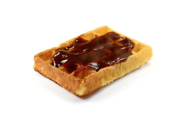 Freshly baked belgian waffles with jam isolated on white background.