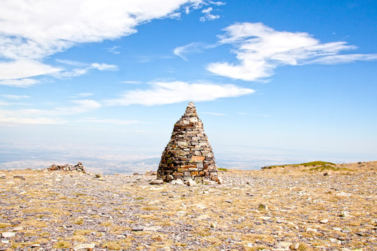 Pillar of stones over the Moncayo mountain with a blue sky in Spain