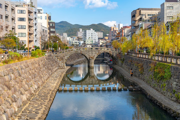 Megane Bridge (Spectacles Bridge) in sunny day with beautiful blue sky reflection on surface. one of the three most famous bridges in Japan. Nagasaki City, Nagasaki Prefecture, Japan