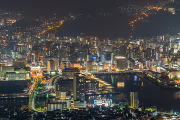 Naklejka premium Nagasaki city light up at night. Panorama nightscape from Mt Inasa observation platform deck. Famous beauty scenic spot in the world, the 10 ten million dollar night views. Nagasaki Prefecture, Japan