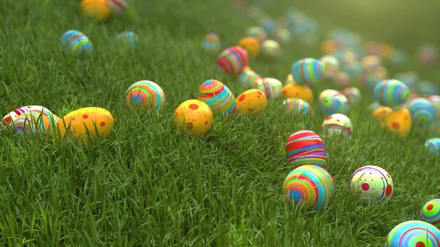 Easter eggs on the grass. Easter eggs slide down the slope covered with green cereal. Sunny positive climate. Beautiful surroundings and cheerful animation.