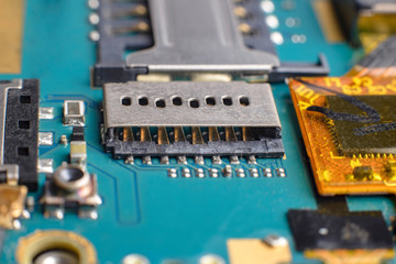 The contact group micro SD card of the smartphone. Blue green printed electronic circuit board of a...