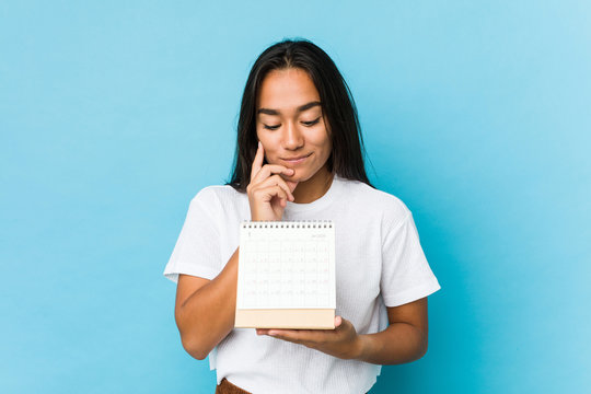 Young indian woman happy holding a calendar isolated