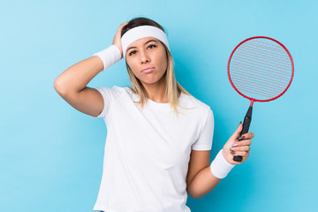Young caucasian woman playing badminton isolated being shocked, she has remembered important meeting.