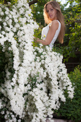 Portrait of beautiful young girl in summer garden.