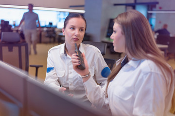 Security guard monitoring modern CCTV cameras in a surveillance room. Group of security guards...