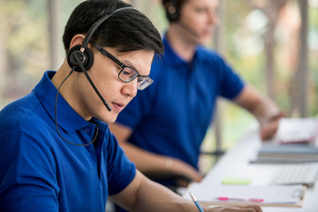 Cute young businessmen and colleagues in the call center office